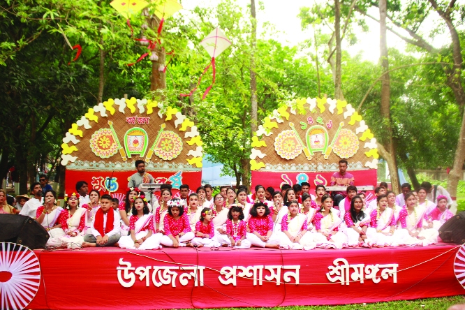 Udichi Shilpi Gosthi, Srimangal performs music at the New Year celebrations organized by Srimangal Upazila Administration to welcome the Bengali New Year' 1429 in front of the Upazila Parishad of Srimangal in Moulvibazar on Thursday.