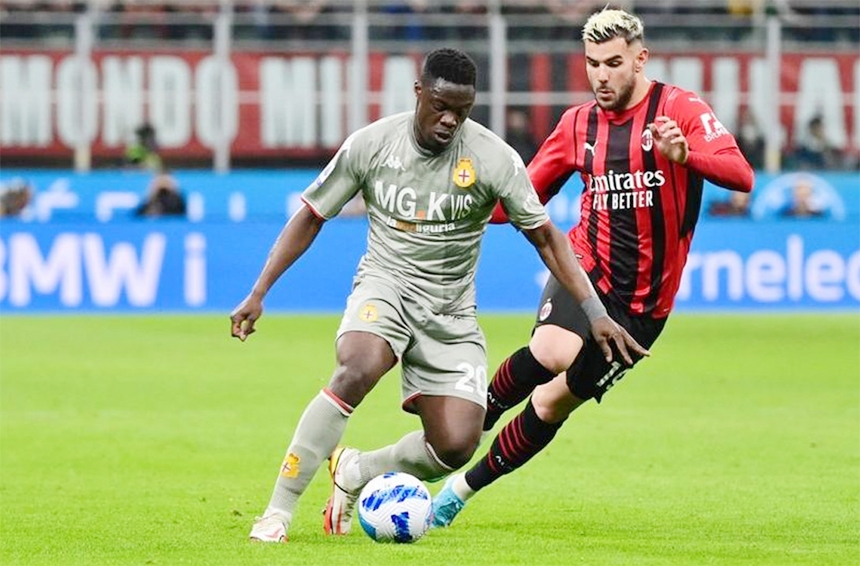 Genoa's Ghanaian forward Caleb Ekuban (left) fights for the ball with AC Milan's French defender Theo Hernandez during the Italian Serie A football match between AC Milan and Genoa at the Giuseppe Meazza Stadium in Milan on Friday.