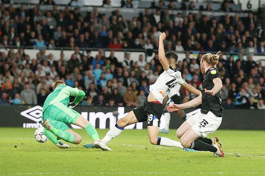 Derby County's Luke Plange (center) scores their side's first goal of the game during the Sky Bet Championship match at Pride Park Stadium, Derby on Friday.