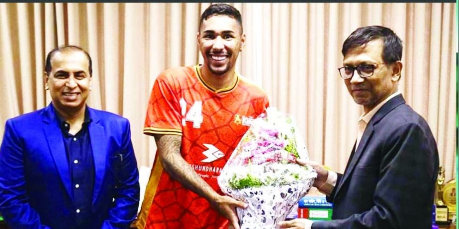 Bashundhara's Brazilian recruit Miguel Ferreira (second from left) receiving a bouquet in the office room of Bashundhara Kings in the city on Sunday. Agency photo