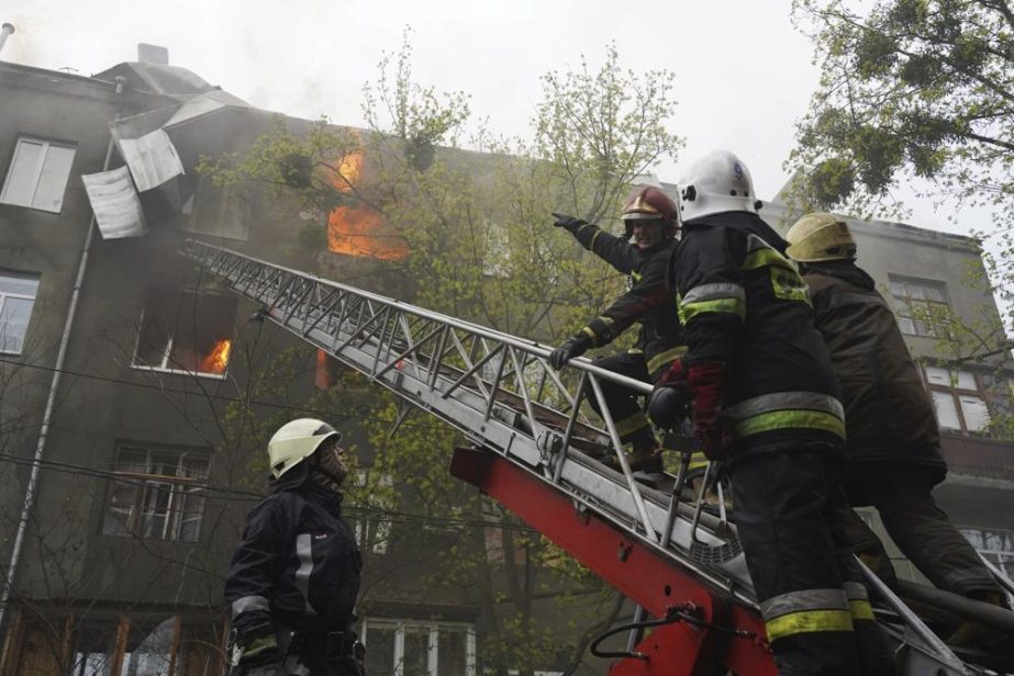 Firefighters work to extinguish fire at an apartments building after a Russian attack in Kharkiv, Ukraine, Sunday, April 17, 2022.