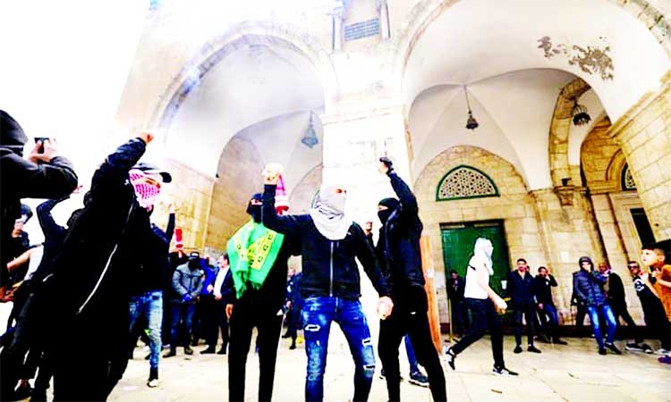 Palestinians demonstrate inside the Al-Aqsa Mosque compound in East Jerusalem on Sunday protesting raids by Israeli police at the holy site. Agency photo