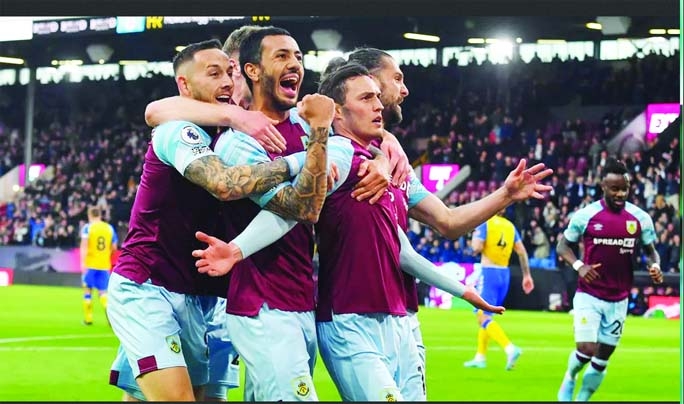 Burnley's Connor Roberts (front) celebrates scoring the opening goal with teammates during the Premier League match between Burnley and Southampton at Turf Moor in Burnley, United Kingdom on Thursday.