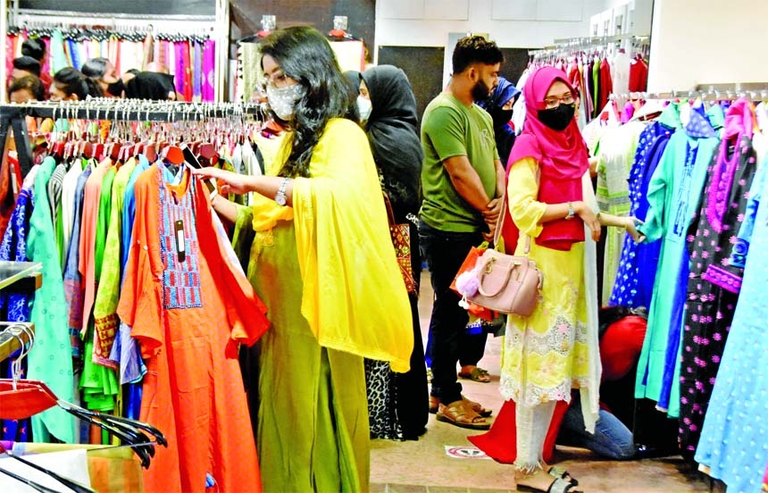 Buyers browse dresses at Basundhara City Shopping Market in the capital on Friday ahead of Eid.