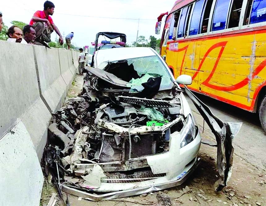 A private car get shredded after being hit a passenger bus at Joypura bus stand in the capital's Dhamrai on Friday.