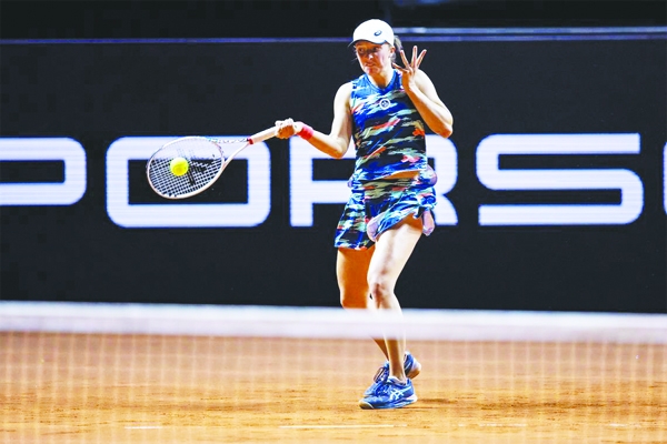 Poland's Iga Swiatek returns a ball during her WTA Tour, quarterfinal tennis match against Britain's Emma Raducanu in Stuttgart, Germany on Friday.