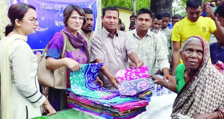 KURIGRAM: Shari and lungis distributes among the needy in Kurigram organised by PashayAsei', an volunteer organization on Friday.