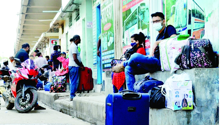 Home-goers wait for bus in city's Gabtoli Terminal on Sunday amid unbearable hot of summer to spend Eid holidays with their near and dear ones.