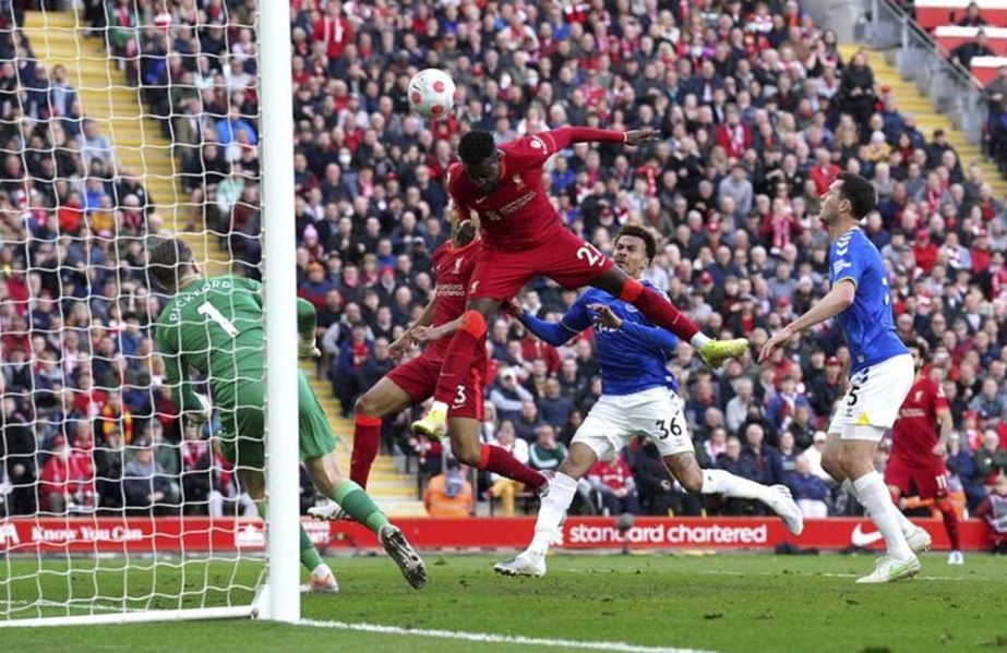 Liverpool's Divock Origi (center) scores his sides second goal during the English Premier League soccer match between Liverpool and Everton at Anfield stadium in Liverpool, England on Sunday. AP photo