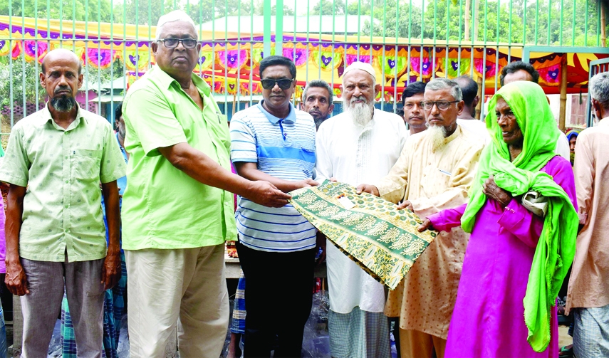 GABTOLI (Bogura): Renowned businessman and popular Awami League leader Alhaj Imran Hossain Ribon distributes clothes among the poor people at Noskoripara in Gobtoli Upazila on Wednesday.