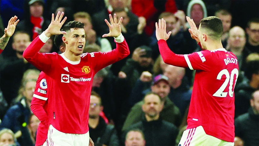 Manchester United's Cristiano Ronaldo (left) celebrates scoring their first goal with Diogo Dalot against Chelsea in their Premier League football match at Old Trafford, England on Thursday.