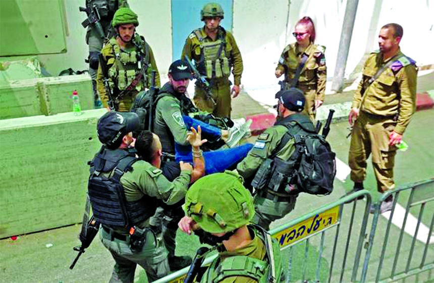 Israeli security forces evacuate a Palestinian man who was denied passage at a checkpoint to reach the city of Jerusalem to attend the last Friday prayers of Ramzan in the al-Aqsa mosque compound, on Friday, in Bethlehem in the occupied West Bank.