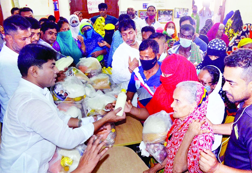 Councillor of 26 No Ward of DSCC Hasibur Rahman Manik distributes food stuff among the destitute at his office premises on Saturday on the occasion of Eid-ul-Fitr.