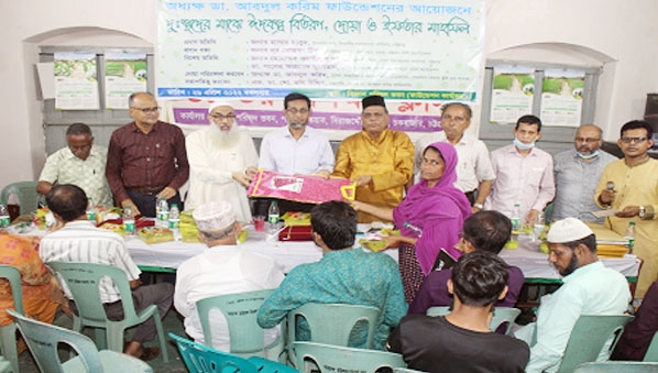Principal Dr.Abdul Karim seen distributing new clothes on the occasion of coming Eid to the hapless women of the society on behalf of the Dr.Abdul Karim Foundation recently.