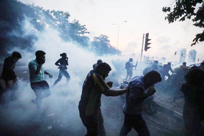 Police lobbed teargas to disperse agitating students trying to storm the Parliament bhavan.