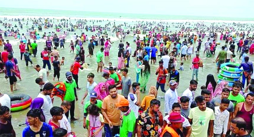 Visitors swarm the Cox's Bazar sea beach on Friday to spend Eid holidays after two years due to strict prohibition amid corona pandemic.