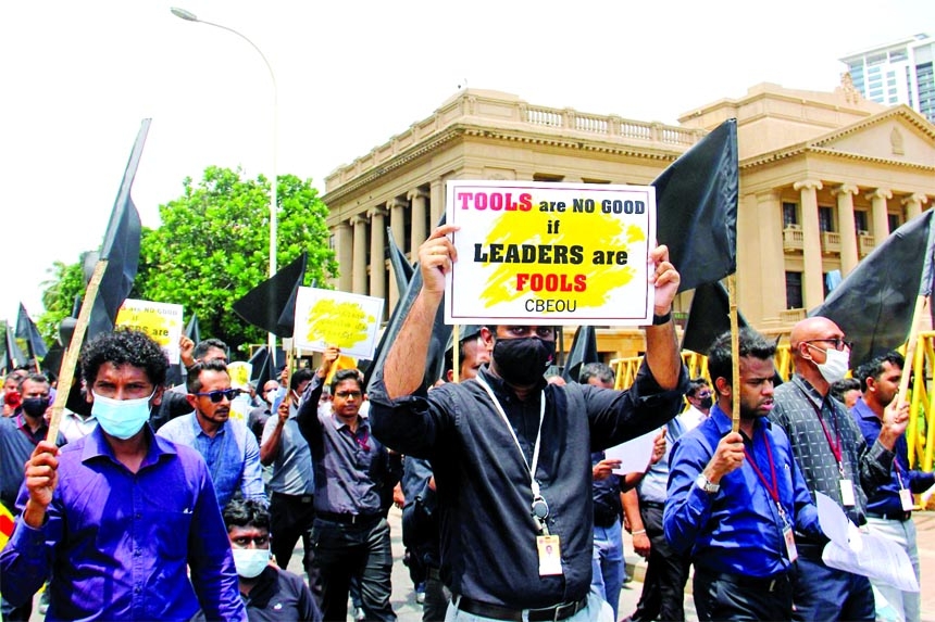 Protesters march outside the president's office in Colombo, Sri Lanka on Friday during a general strike called by trade unions to demand the resignation of President Gotabaya Rajapaksa.