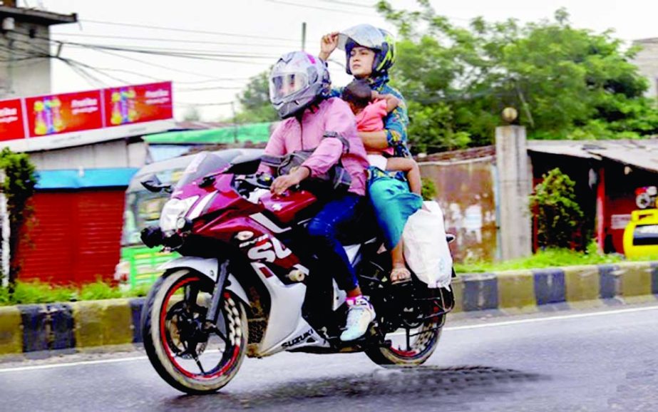 A couple and their child return to Dhaka by a motorcycle through the Dhaka-Chattogram Highway on Friday after the Eid-ul-Fitr holidays. Agency photo