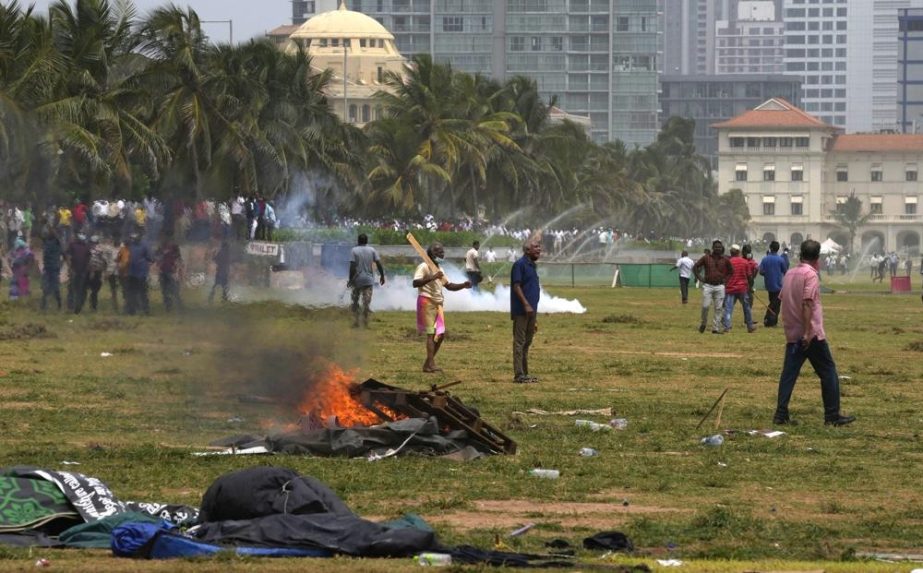 Sri Lanka's pro government supporters vandalise the camps of anti government protestors outside the president's office in Colombo, Sri Lanka, Monday, May 9, 2022.
