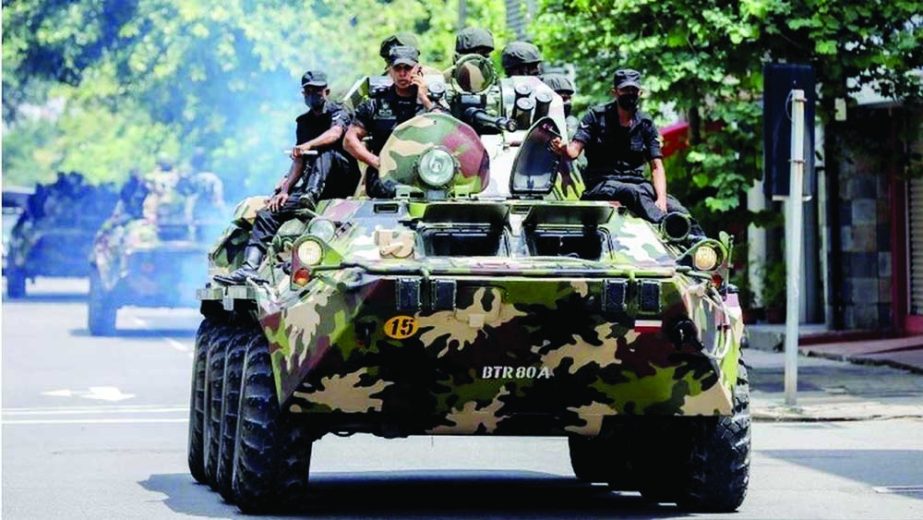 Army soldiers seen on armoured cars in Colombo, Sri Lanka on Wednesday after the curfew was extended by a day following clashes between government loyalists and anti-government demonstrators. Agency photo