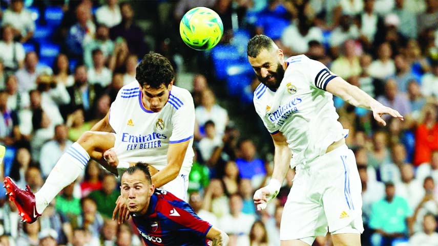 Real Madrid's Karim Benzema ( right) scores their second goal against Levante during their Spanish La Liga match at the Santiago Bernabeu on Thursday.