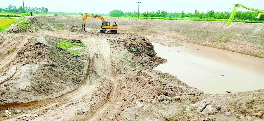 BHANGURA (Pabna): The Vacu machine digs a canal for commercial purpose near Chandipur cemetery in the Bhangura upazila of Pabna on Sunday.
