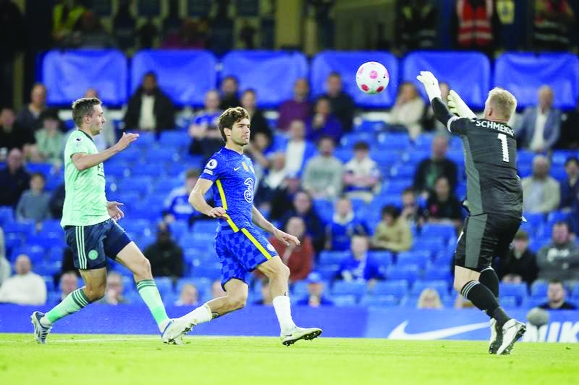 Leicester's goalkeeper Kasper Schmeichel (right) makes a save in front of Chelsea's Marcos Alonso (center) during the English Premier League soccer match between Chelsea and Leicester City at Stamford Bridge stadium in London on Thursday.