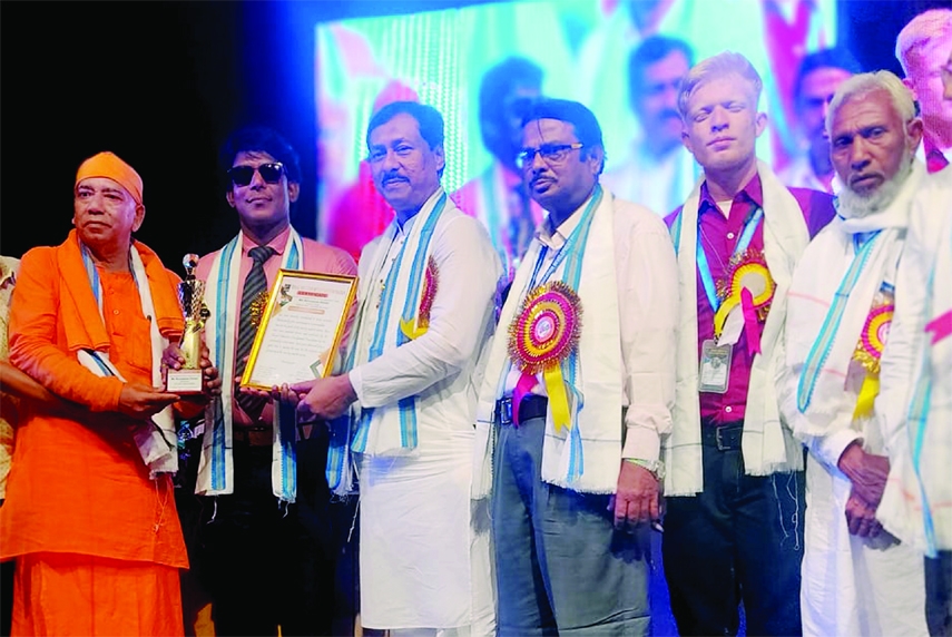 RANGPUR: Md. Nuruzzaman Ahmed, Executive Director of Profit Foundation of Kaliganj Upazila, a prominent social worker of Rangpur confers a honorary crest at the Science City Auditorium in Kolkata, India recently.