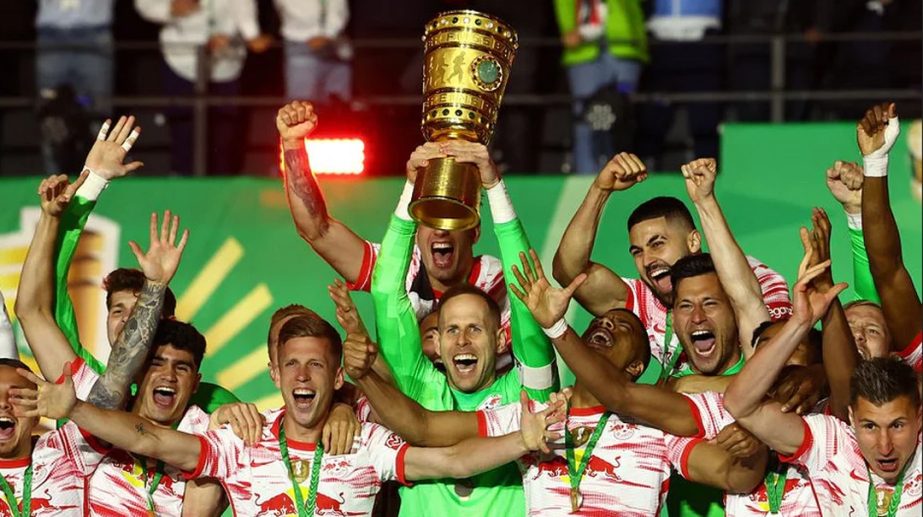 RB Leipzig's Peter Gulacsi lifts the trophy as he celebrates winning the final with teammates. Agency photo