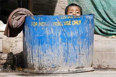 A boy cools off while sitting in a water tub along the roadside on a hot summer day in New Delhi on Monday. Agency photo