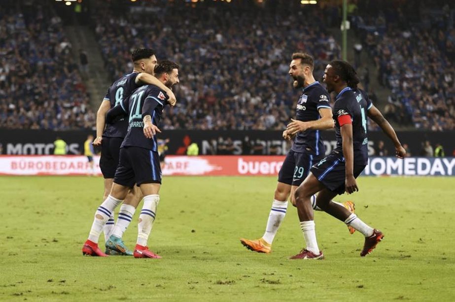 Hertha players celebrate after avoiding relegation from the Bundesliga, after the German Bundesliga relegationpromotion playoff soccer match against Hamburg at the Volksparkstadion in Hamburg, Germany on Monday. AP photo