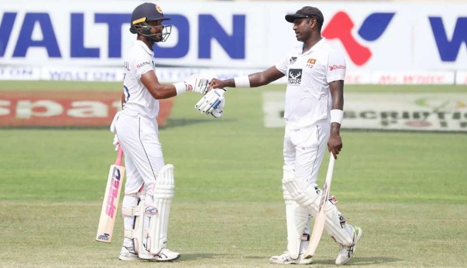 Dinesh Chandimal (left) of Sri Lanka celebrates with Angelo Mathews after hitting a four against Bangladesh on the fourth day of the second Test at the Sher-e-Bangla National Cricket Stadium in the city's Mirpur on Thursday. NN photo