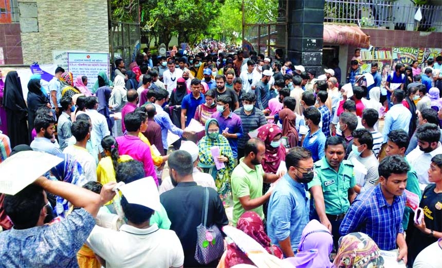 Guardians of 44th BCS preliminary examination candidates swarm in front of Azimpur Govt. Girls School & College on Friday.