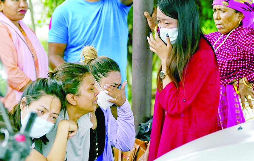 Family members and relatives of passengers on board the Twin Otter aircraft operated by Tara Air, weep outside the airport in Pokhara, Nepal on Sunday.