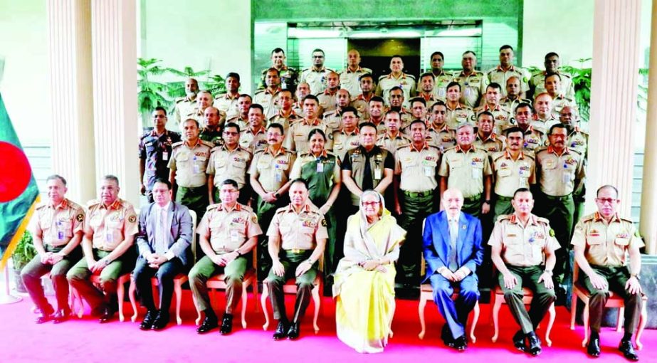 Prime Minister Sheikh Hasina poses for a photo session with the Board of Army Selection at the Multipurpose Complex of Dhaka Cantonment on Monday. PID photo