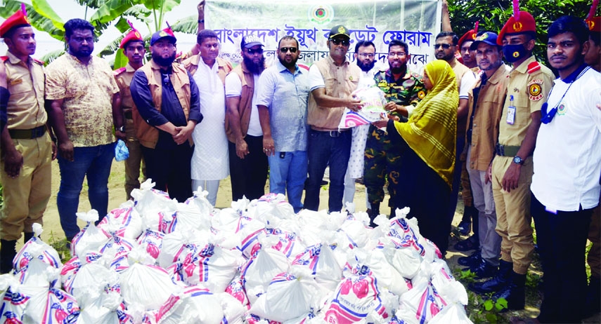 SYLHET: Lt Md Monirul Islam, Assistant Professor Modan Mahan College, Sylhet distributes reliefs as the Chief Guest among the flood- hits at Dakkin Surma Upazila organised by Bangladesh Youth Cadet Forum recently.