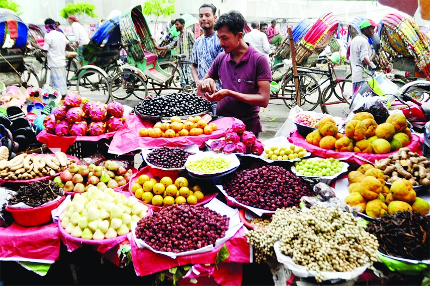A vendor stands in front of his shop that was replete with seasonal fruits. This photo was taken from capital's Palton area on Monday.