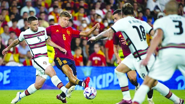 Portugal's defender Raphael Guerreiro (left) vies with Spain's midfielder Marcos Llorente during the UEFA Nations League, league A group 2 football match between Spain and Portugal, at the Benito Villamarin stadium in Seville on Thursday.