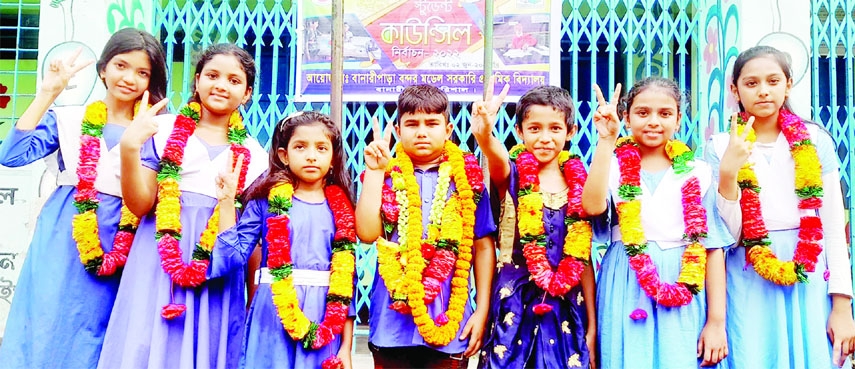 BANARIPARA (Barishal): Winners of Student Council Election of Bandar Model Government Primary in Banaripara Upazila show V-sign after the election on Thursday.
