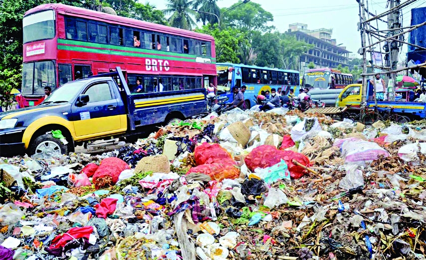 A slew of garbage is seen beside the main road of Old Dhaka's Nayabazar area on Saturday. As a result, the environment of that area got contaminated.