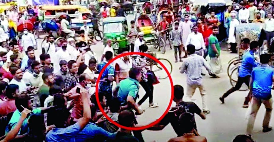 A traffic police sergeant comes under attack from a group of people in Dhaka's Jurain area on Tuesday morning following an altercation with a motorcycle rider. NN photo