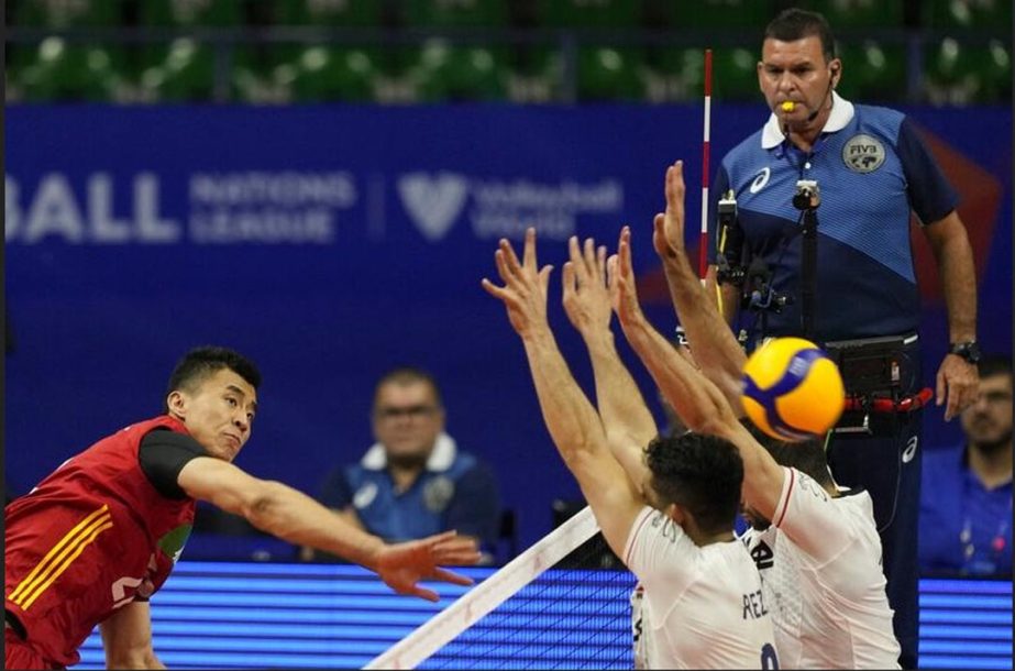 China's Zhang Jingy (left) in spikes the ball during a men's Nations League volleyball match against Iran, in Brasilia, Brazil on Tuesday. AP photo