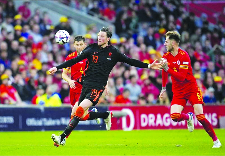 Netherlands' Wout Weghorst (front, left) duels for the ball with Wales' Joseph Peter Rodon (right) during the UEFA Nations League soccer match between Wales and the Netherlands at Cardiff City Stadium in Cardiff, Wales on Wednesday.