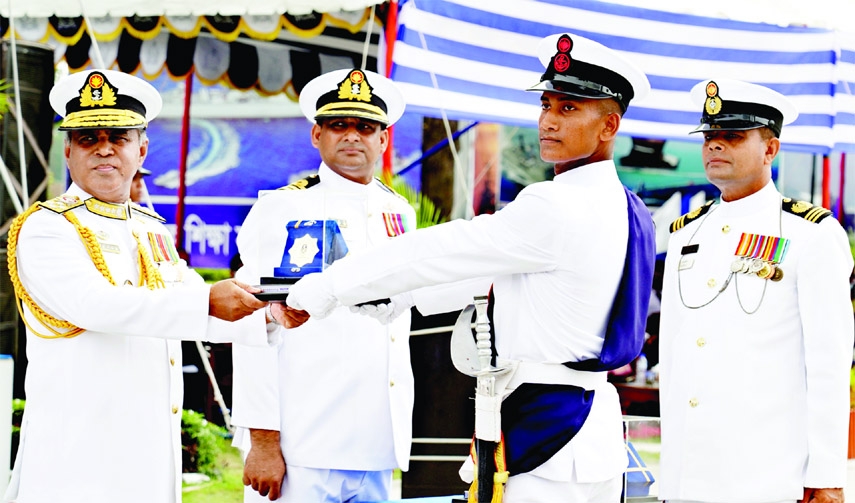 Chief of Naval Staff Admiral M. Shaheen Iqbal hands over 'Navy Chief Medal' to all rounder sailor Faisal Mahmud at a parade of new sailors at BNS Titumir Parade ground in Khulna on Thursday.