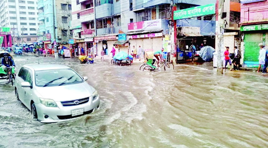 A car wading through flooded street at Mirpur in Dhaka on Thursday as monsoon rain created waterlogging in different parts of the capital.