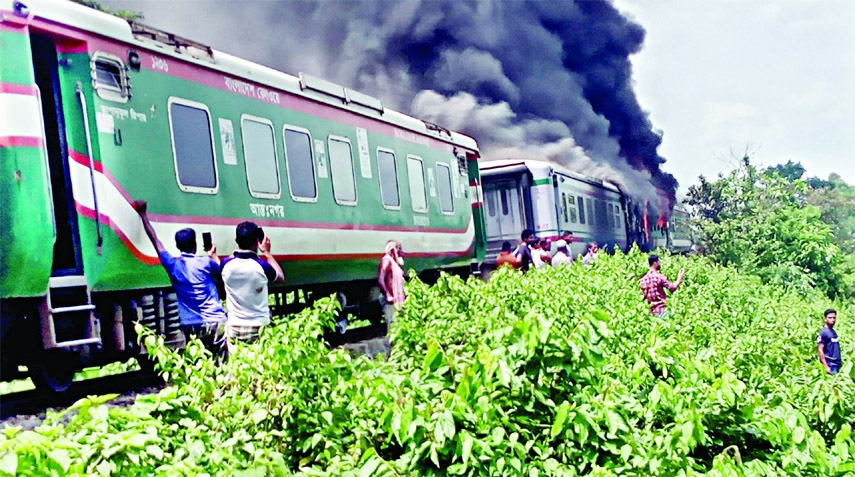 Smoke billows from two bogies of Sylhet-bound Parabat Express as a fire that broke out at Dukbel area in the midst of Shamshernagar and Manu station of Sylhet-Akhaura section on Saturday.