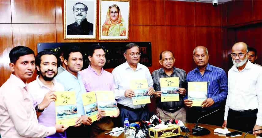 Information and Broadcasting Minister Dr. Hasan Mahmud , among others, holds the copies of 'BSRF Barta' Souvenir on its cover unwrapping ceremony organised by BSRF at the seminar room of the ministry on Thursday.