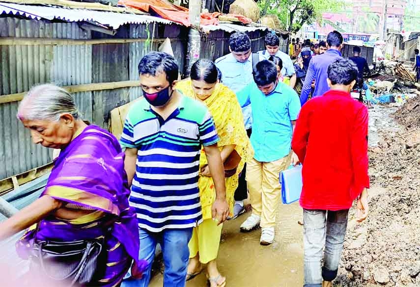 Pedestrians move through a congested thoroughfare with heavy predicament as construction firms filled road with earth as part of development works in the capital. This photo was taken from Shakhari Bazar Road behind Judge Court on Thursday.