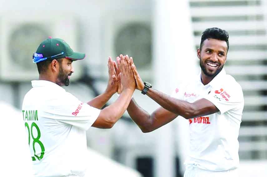 Ebadot Hossain (right) of Bangladesh celebrates with Tamim Iqbal after dismissal of Raymon Reifer (not in the picture) of West Indies during the first day play of the first Test at Sir Vivian Richards Stadium in North Sound, Antigua on Thursday.