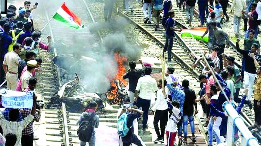 Protesters set a train on fire during a demonstration against India's new scheme of military hiring in Secunderabad city of the southern state of Telangana on Friday.
